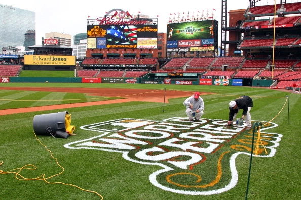 Workers paint a 2011 World Series logo on the field at Busch Stadium Workers paint a 2011 World Series logo on the field at Busch Stadium